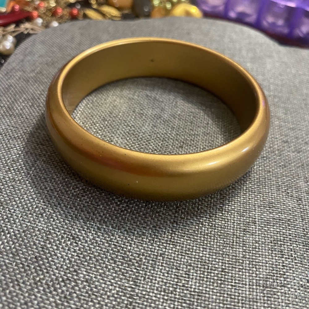 Gold colored bangle bracelet.  Average size.